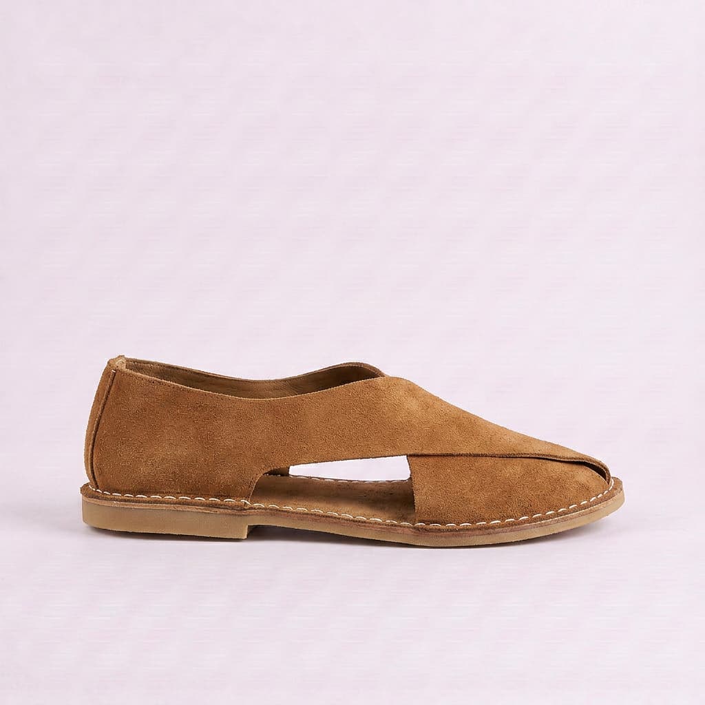 Brown sandal on a light purple background