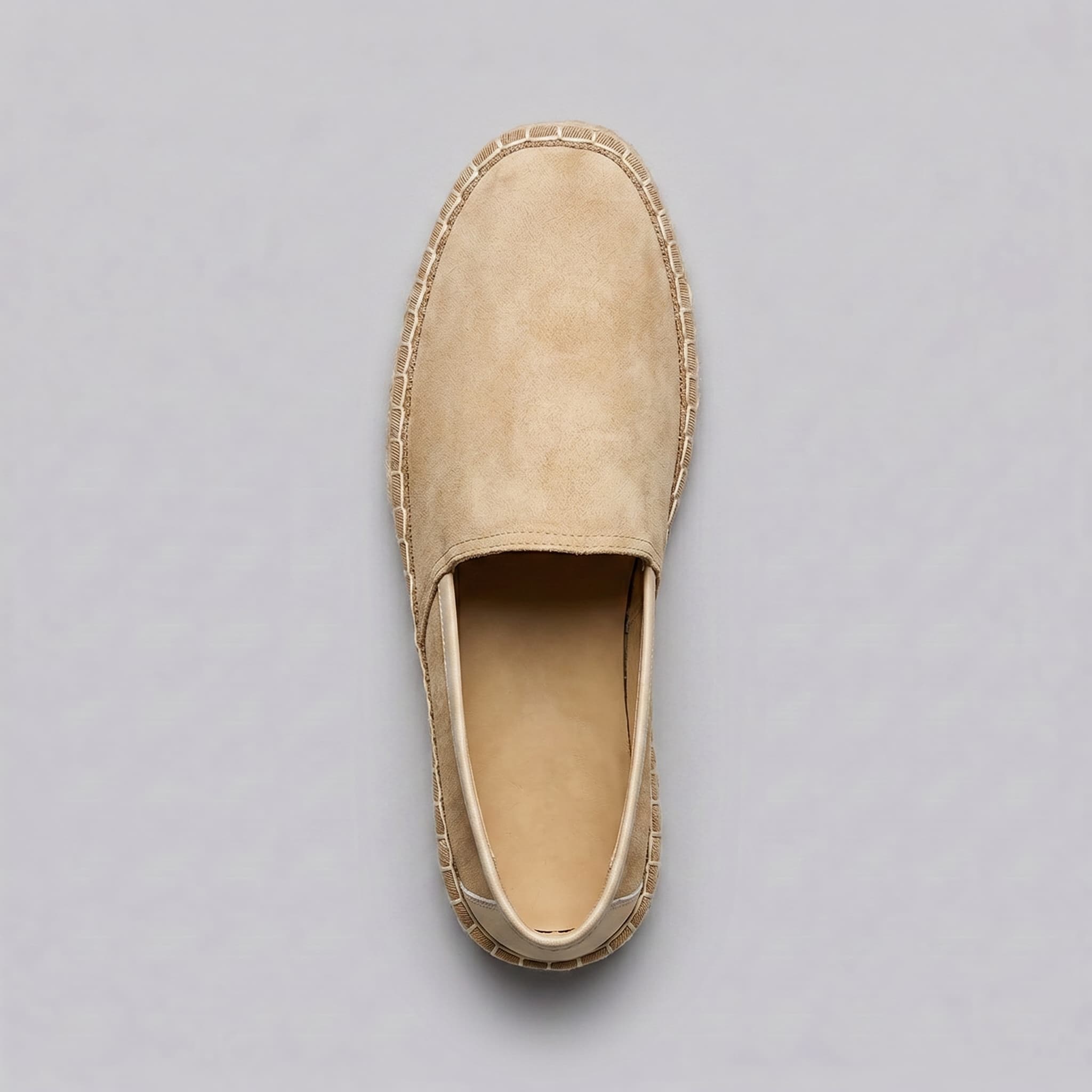 Beige espadrille shoe on a gray background