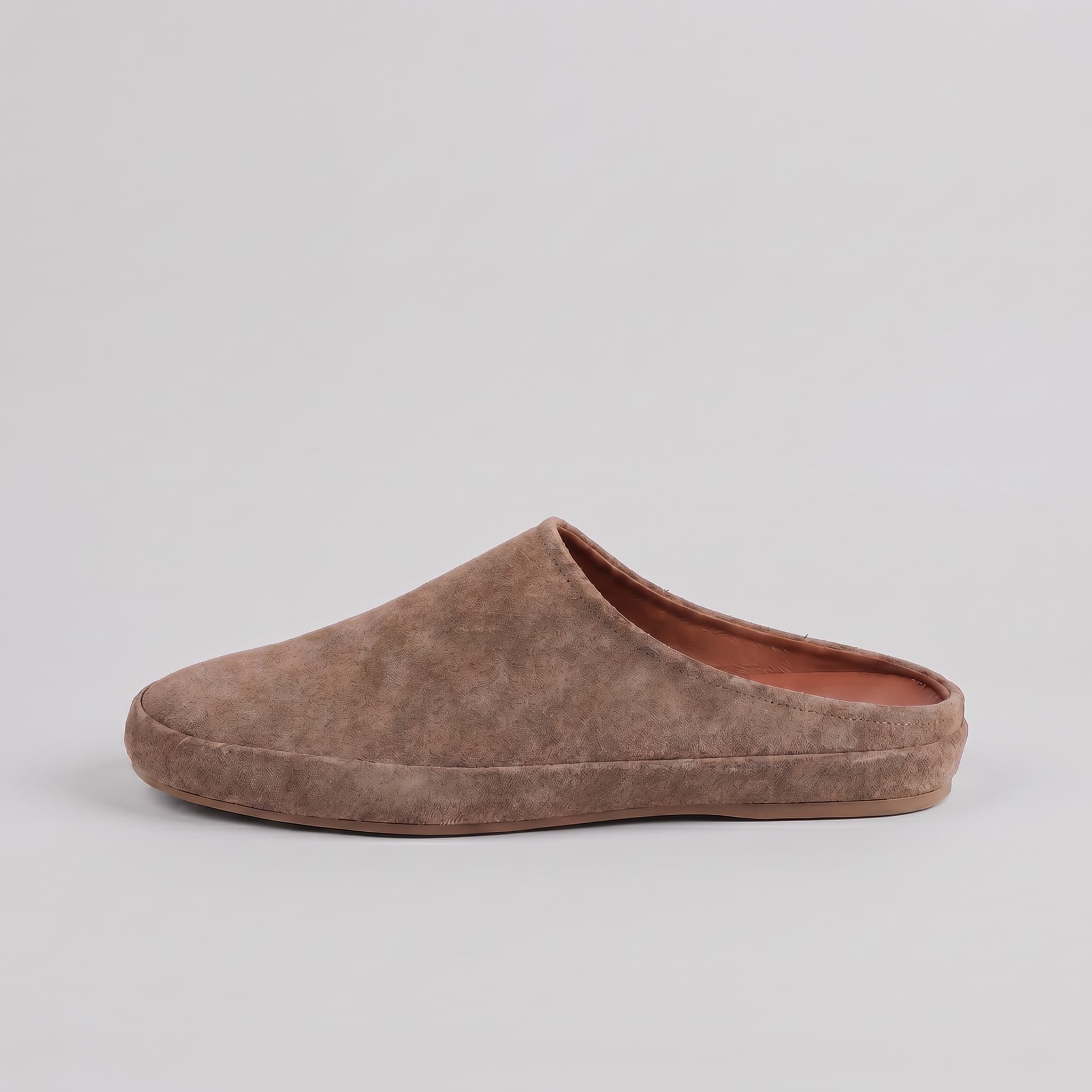 Brown slip-on shoe on a light gray background