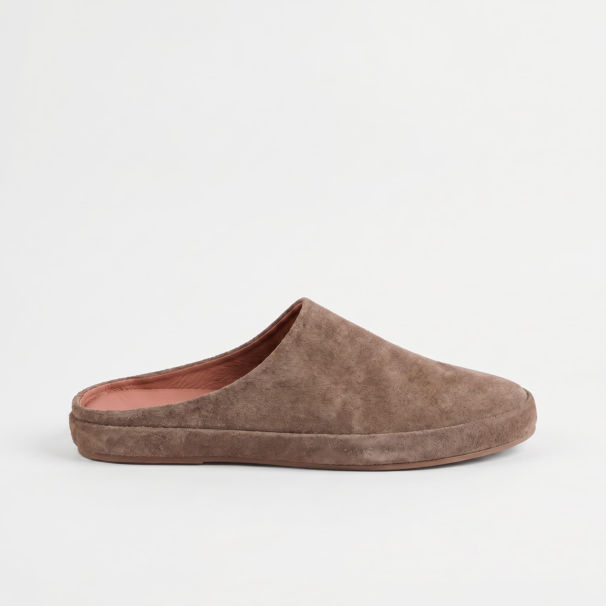 Brown suede slipper on a light gray background