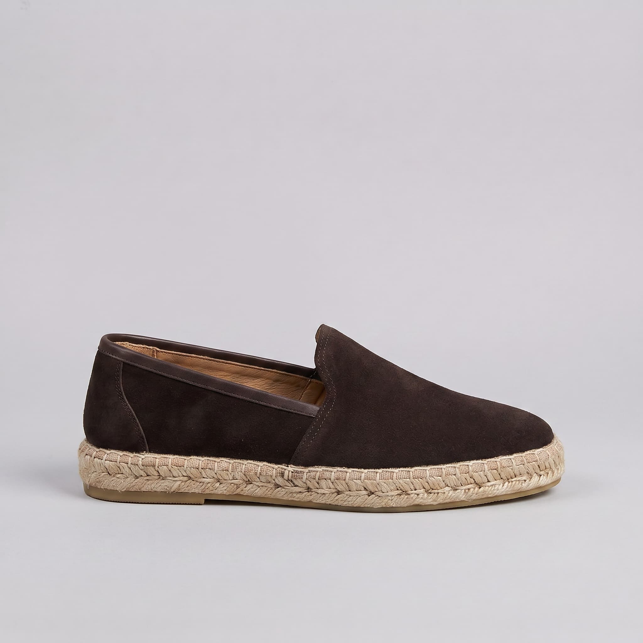 Brown leather sneakers with white soles on a white background