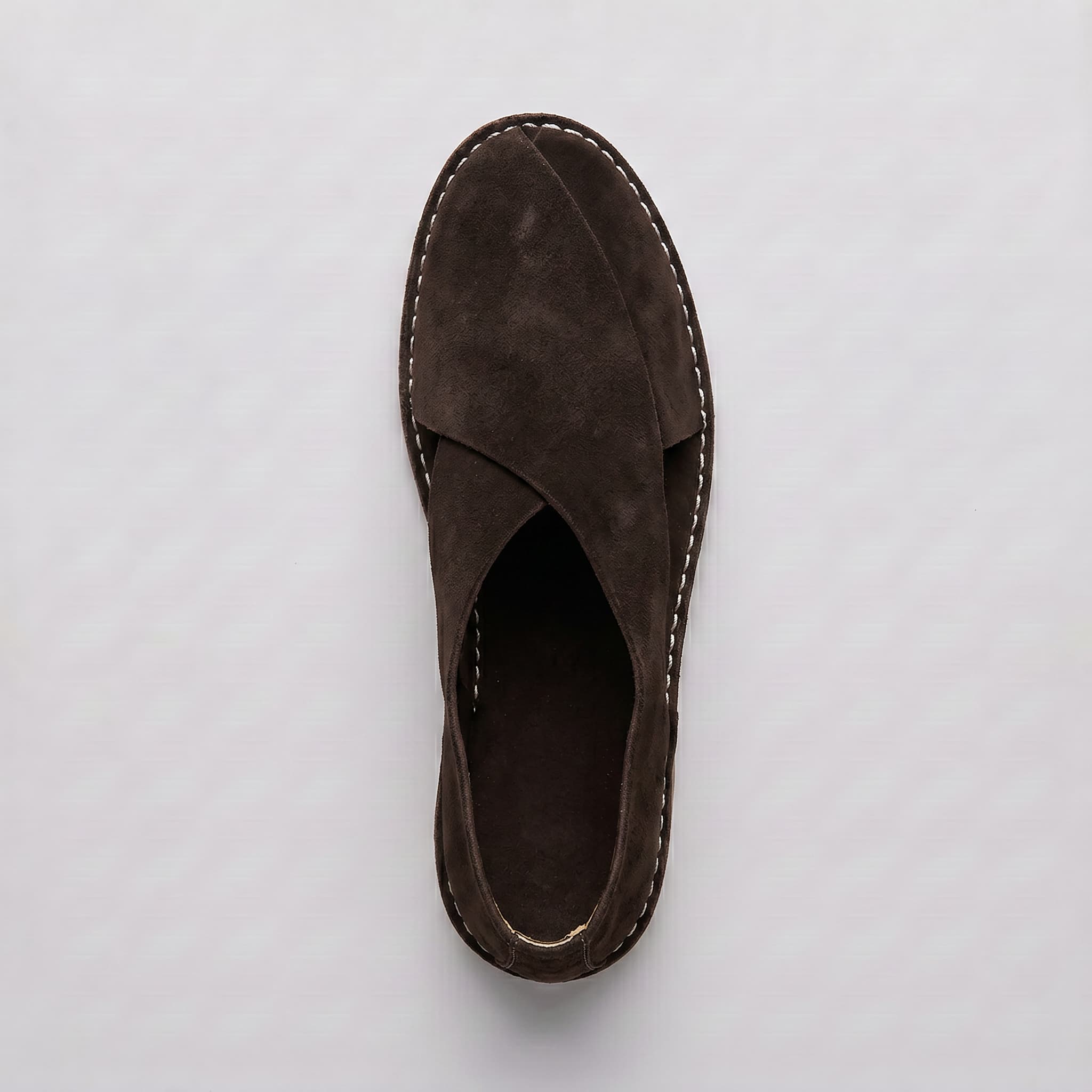 Brown suede sandal on a light gray background