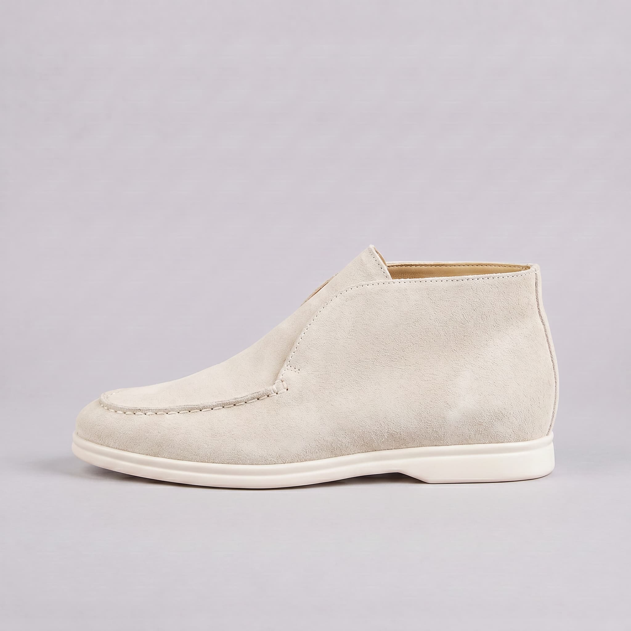 White suede shoe on a gray background
