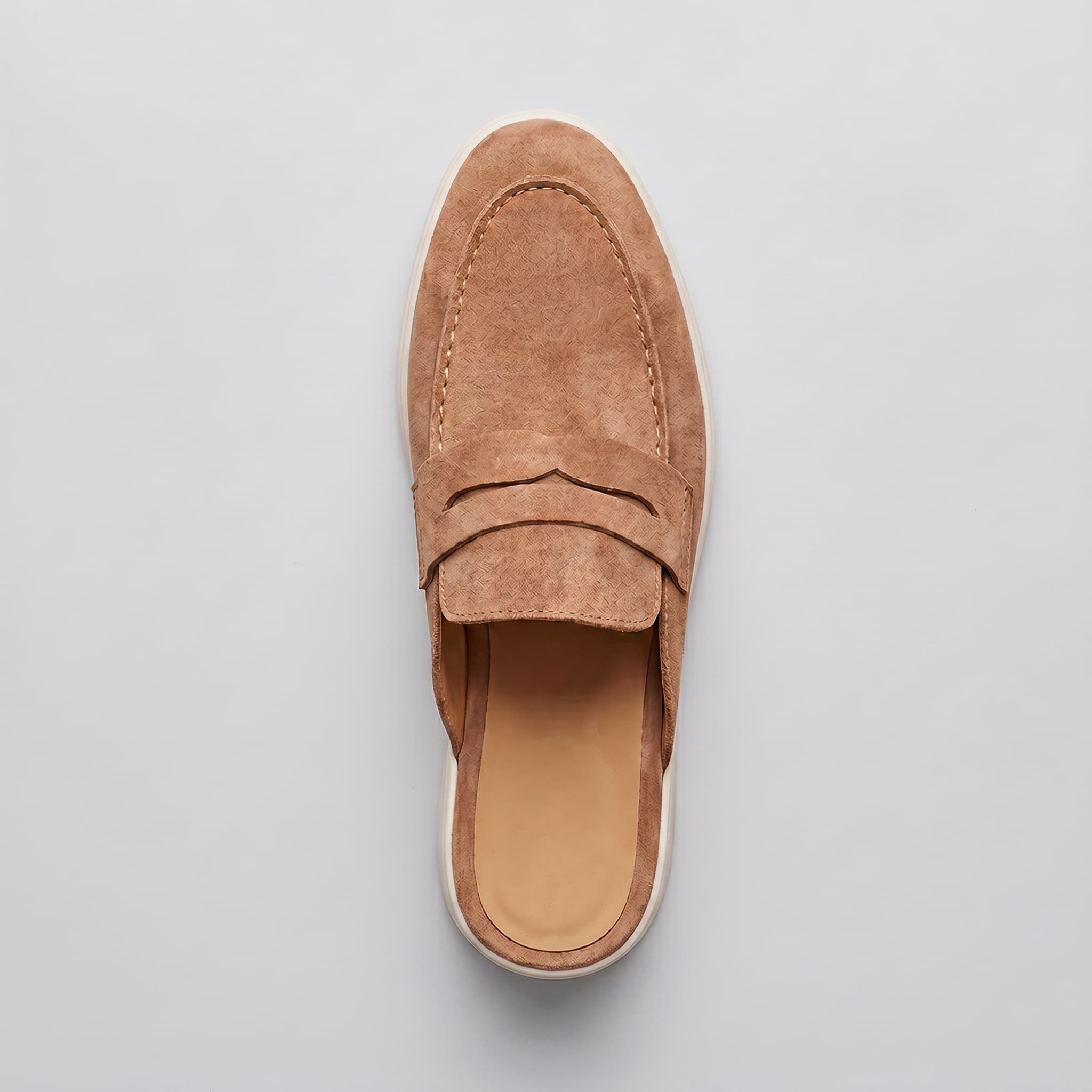 Brown suede loafer on a light gray background