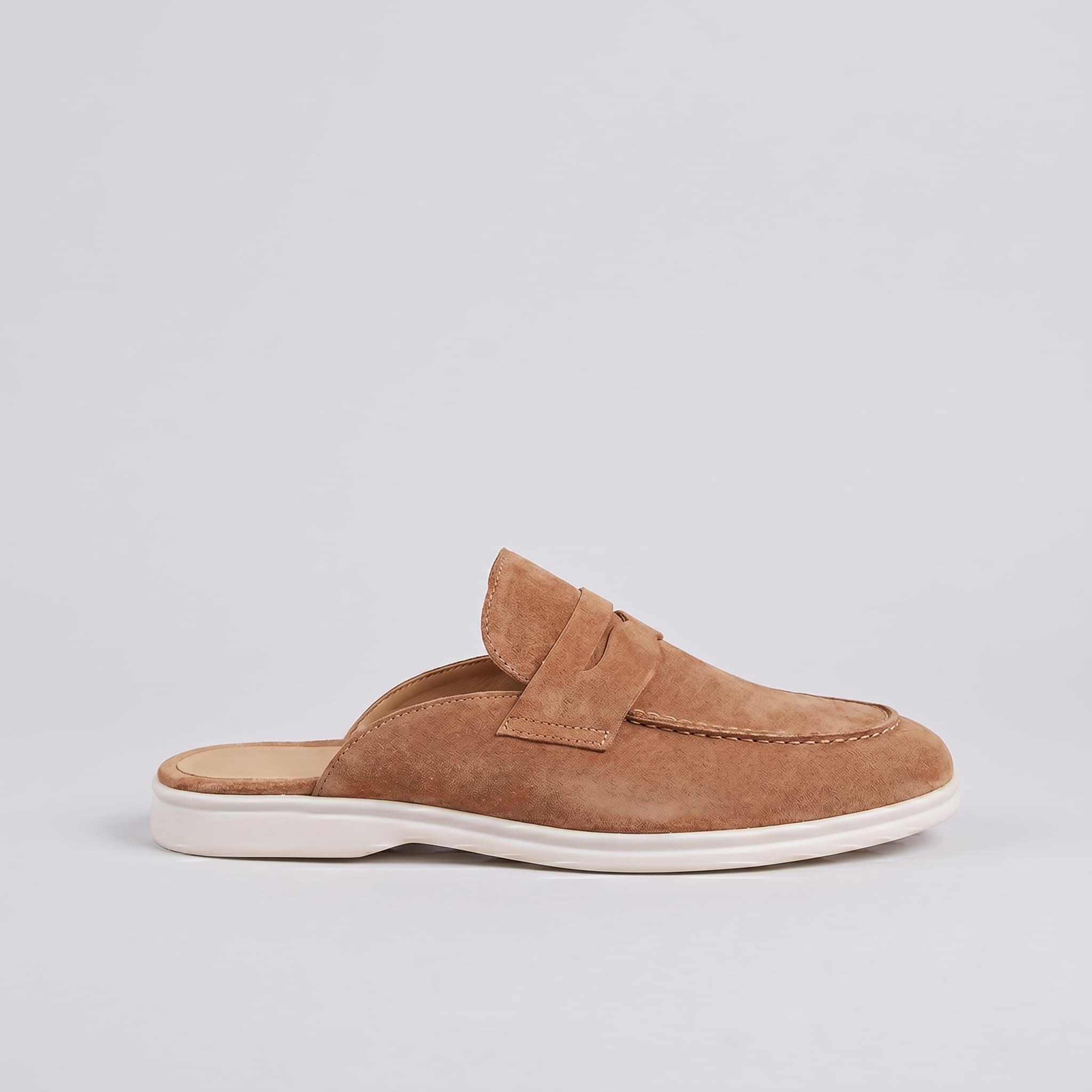 Brown slip-on shoe with a white sole on a light gray background