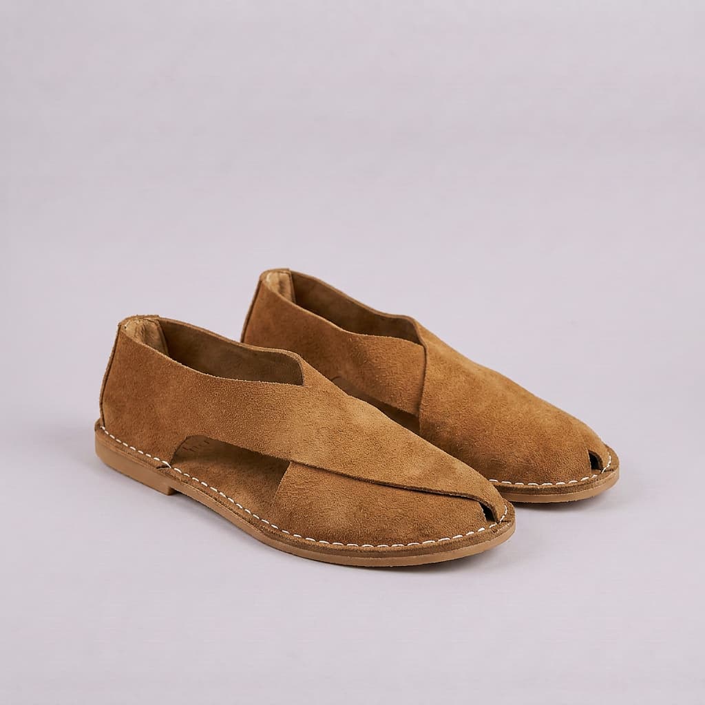 Pair of brown suede open-toe shoes on a light gray background