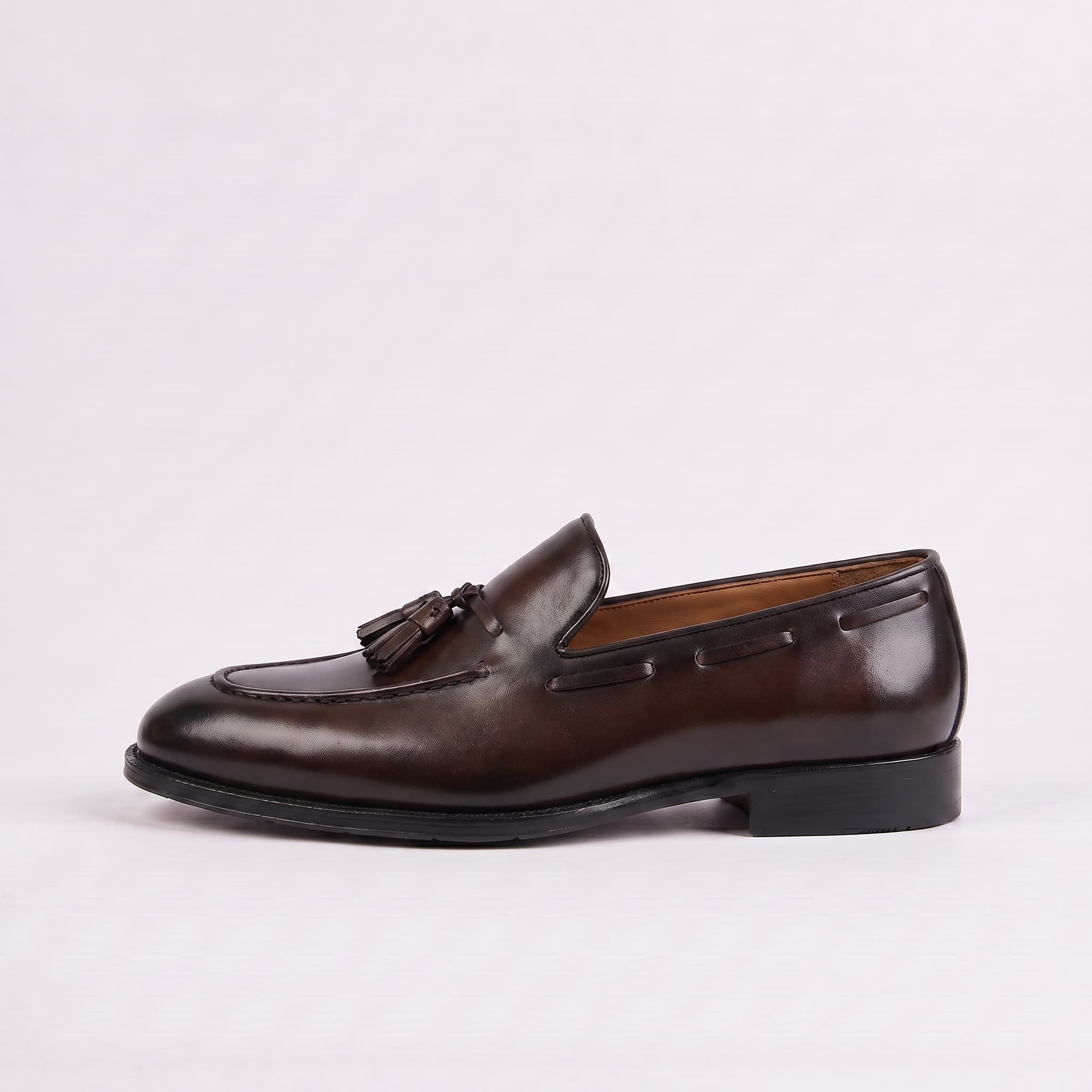 Pair of olive green clogs with brown soles on a white background