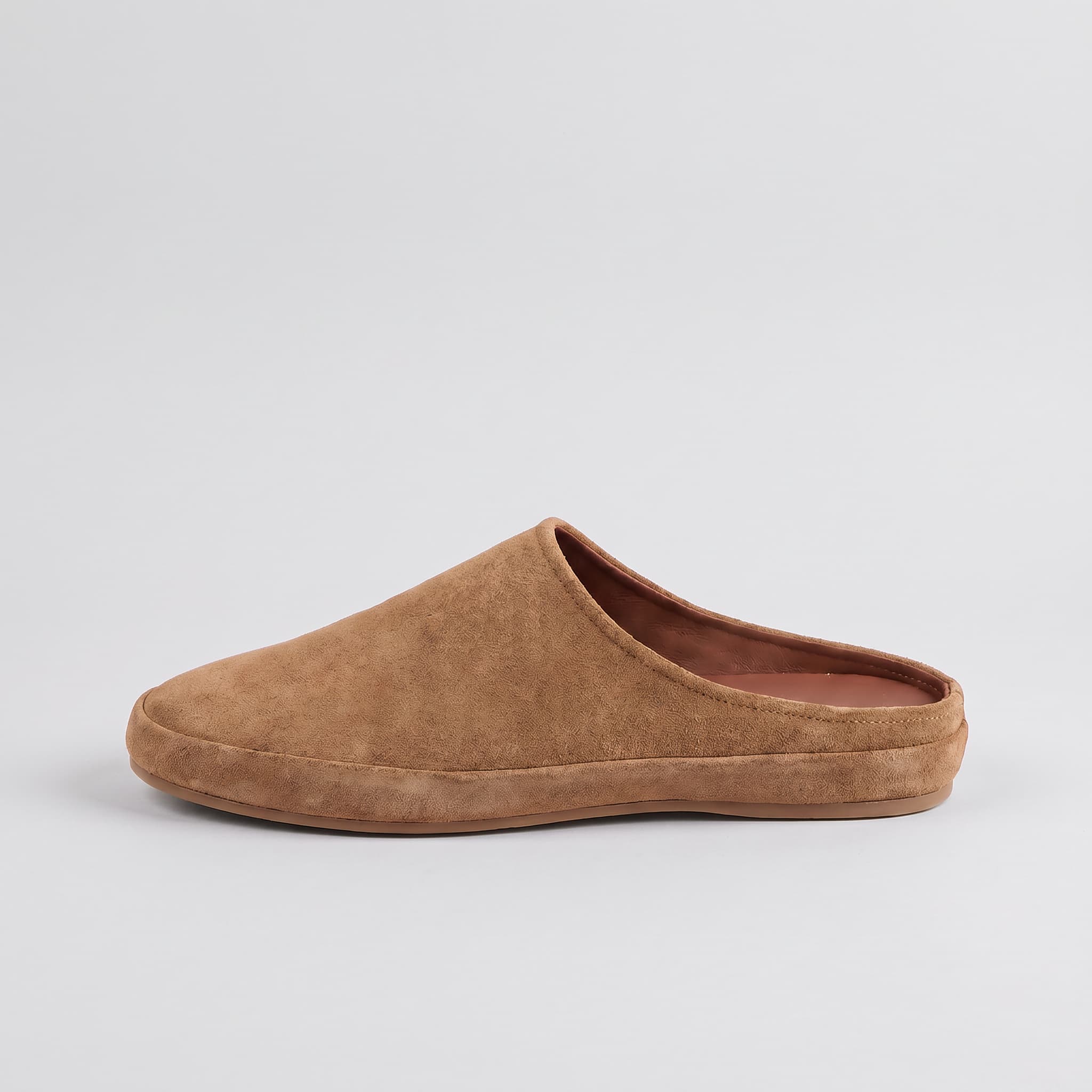 Brown slip-on shoe on a light gray background