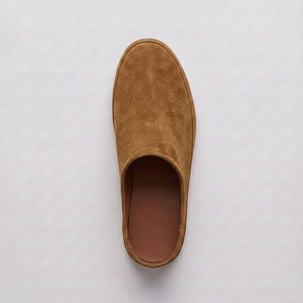 Brown slip-on shoe on a light gray background