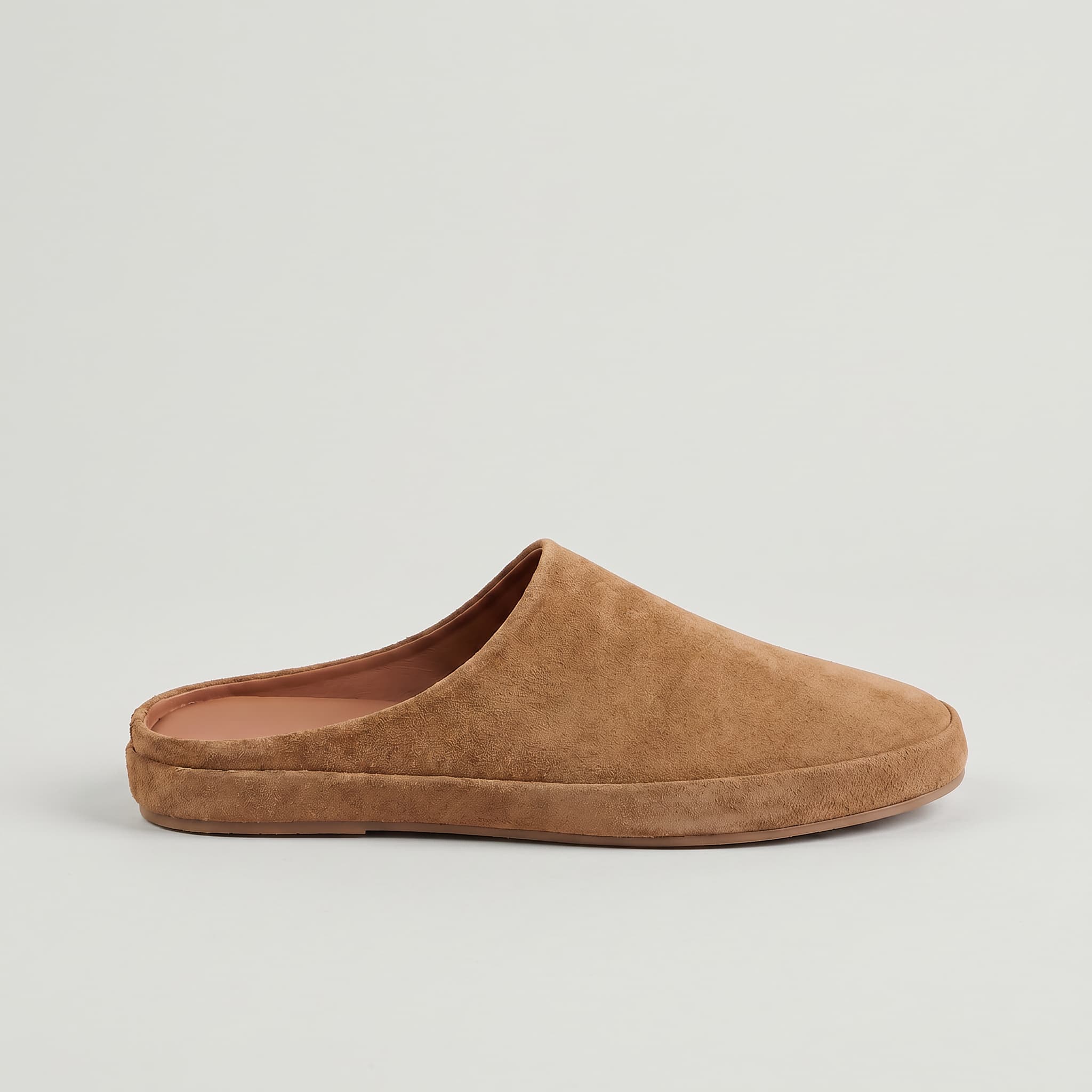 Brown slip-on shoe on a light gray background