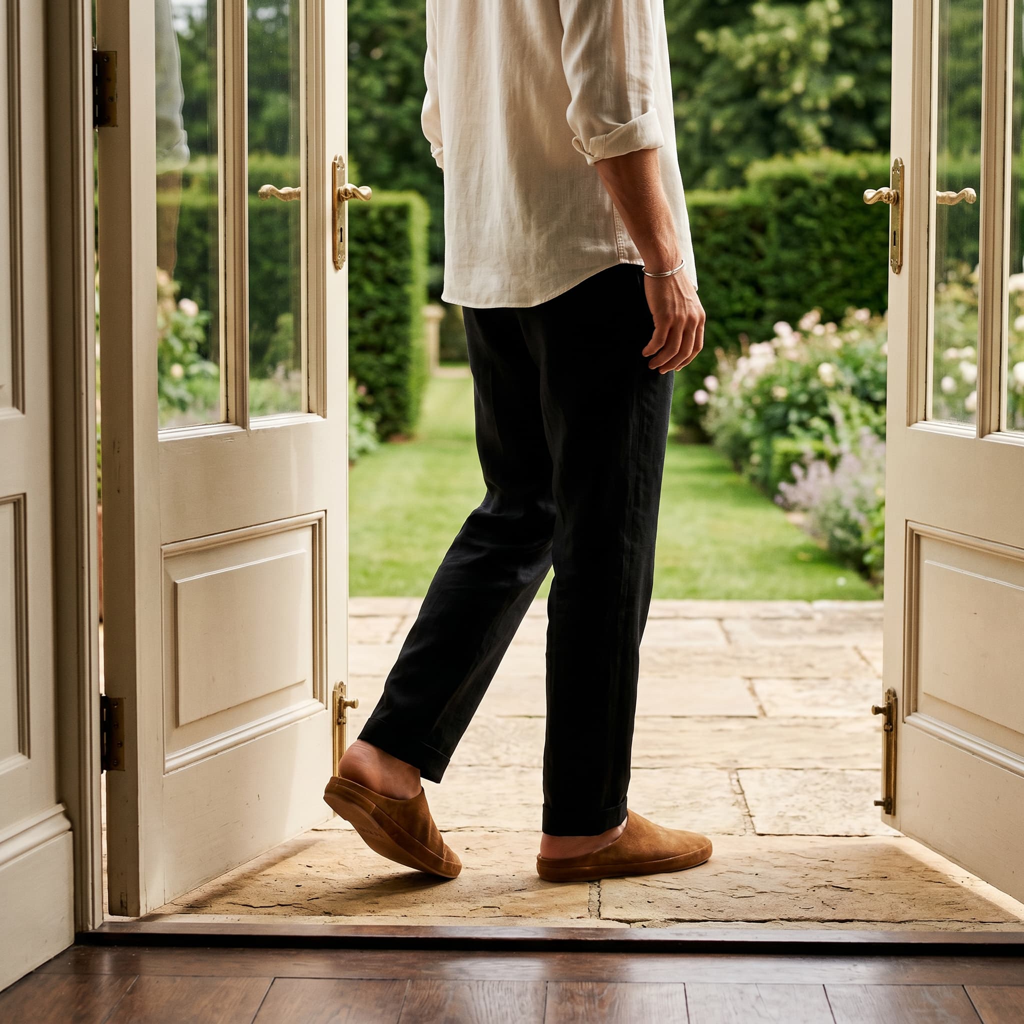 Person stepping out of a door onto a garden path