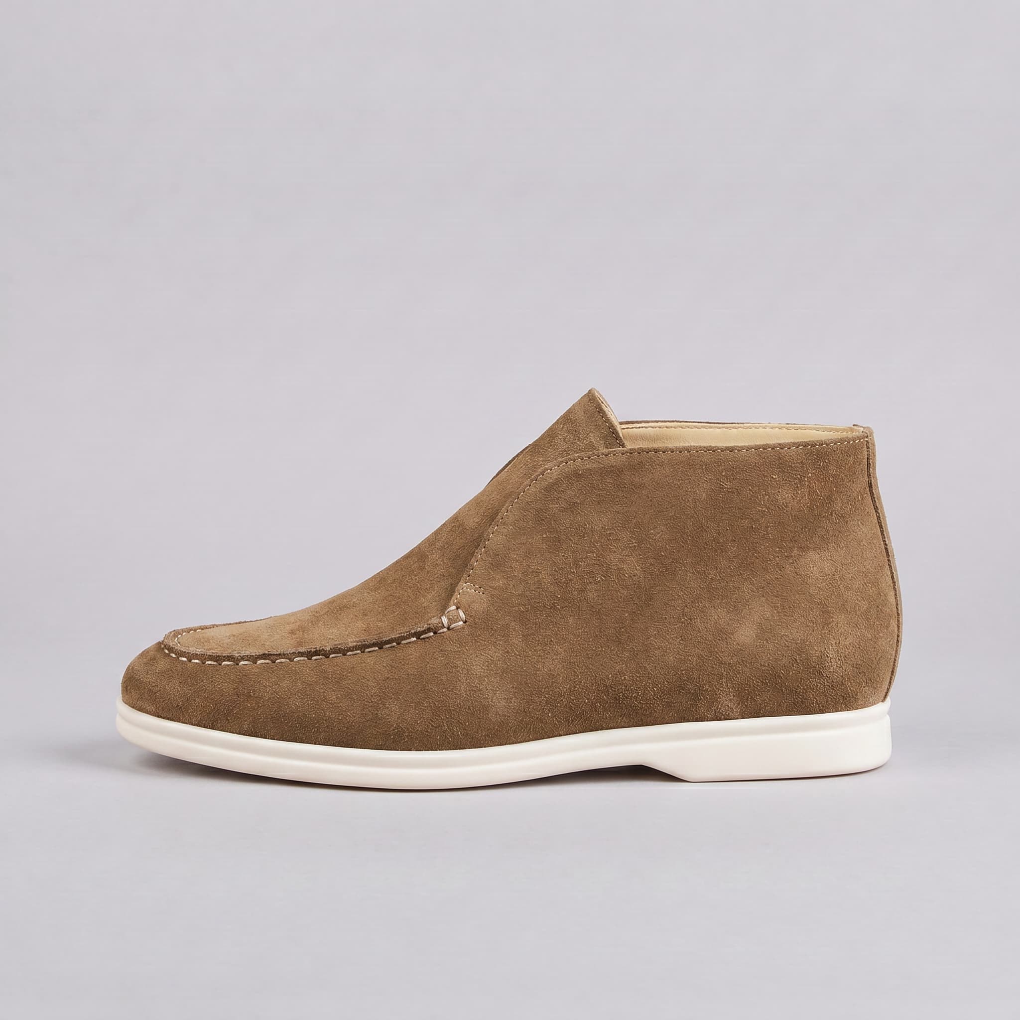 Brown suede shoe on a gray background