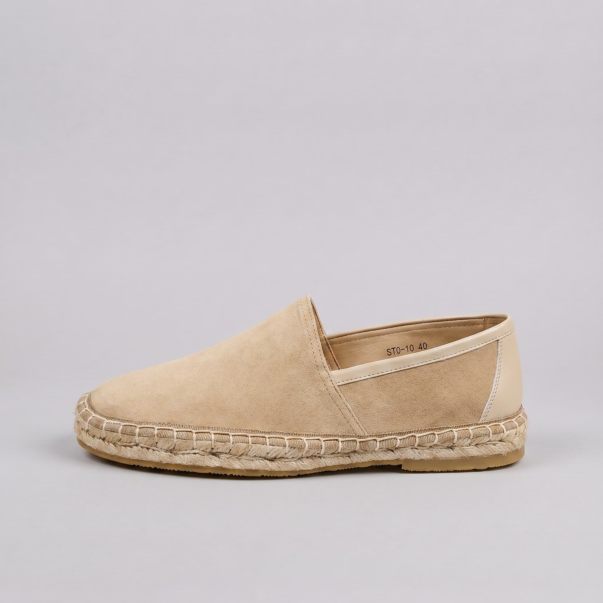 Beige espadrille shoe on a gray background