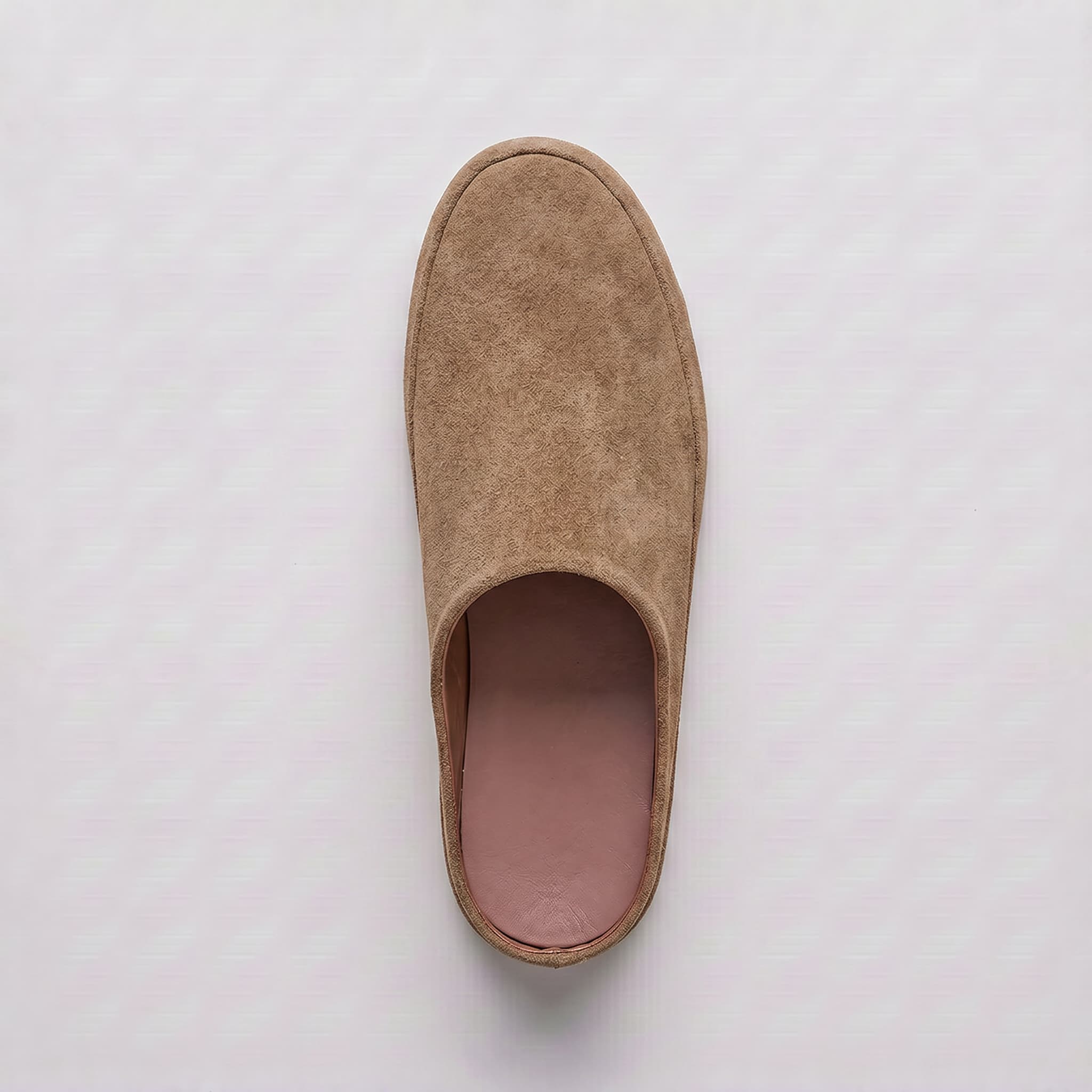 Beige slipper on a light gray background