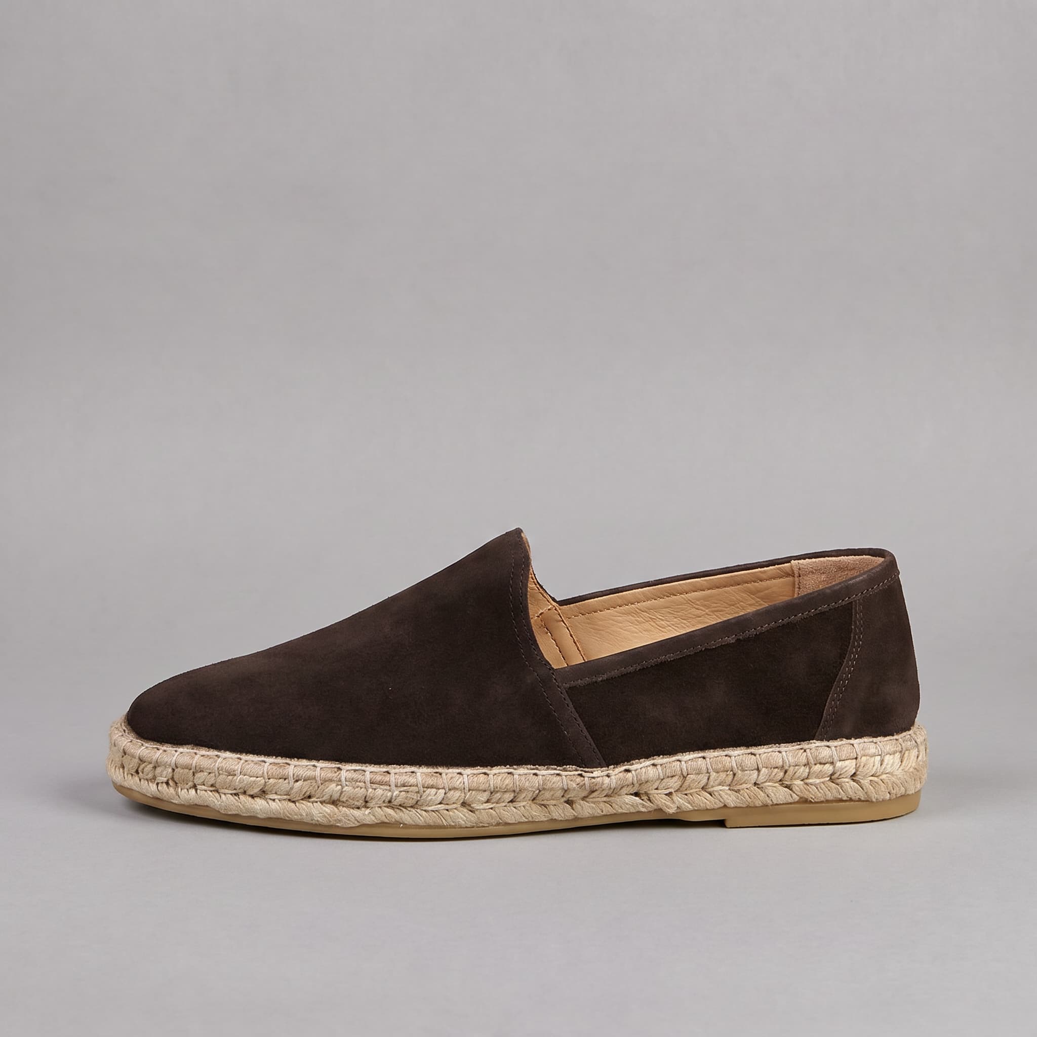 Brown espadrille shoe on a gray background