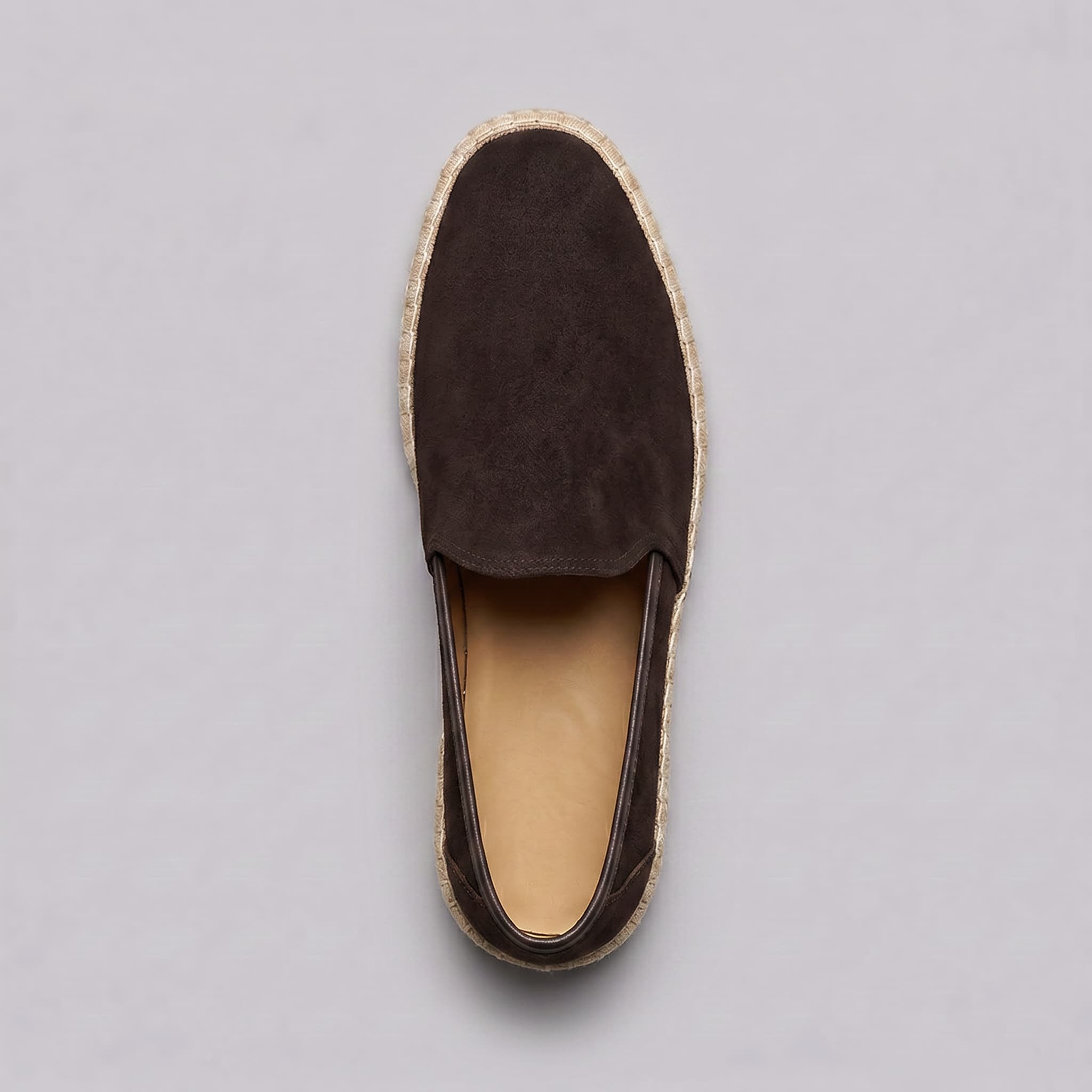 Brown espadrille shoe on a gray background