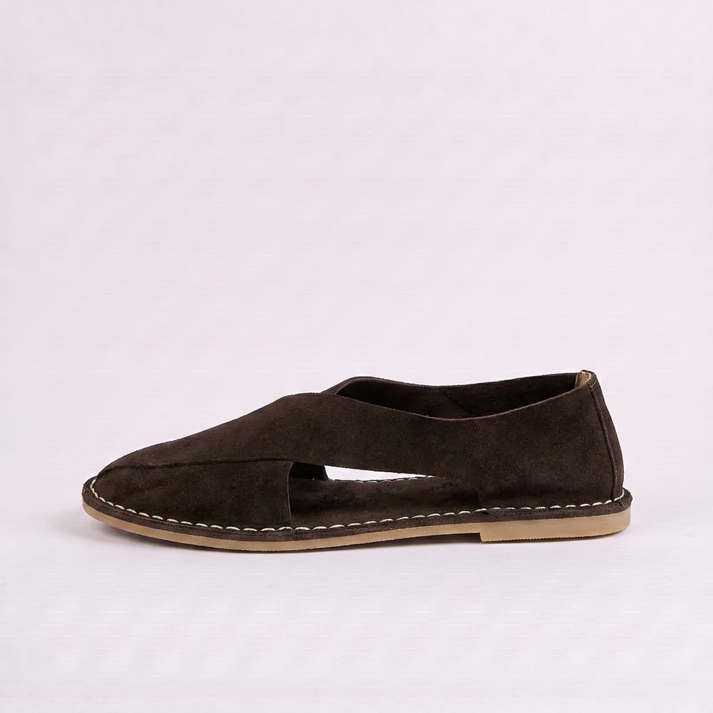 Brown suede flat shoe on a light gray background