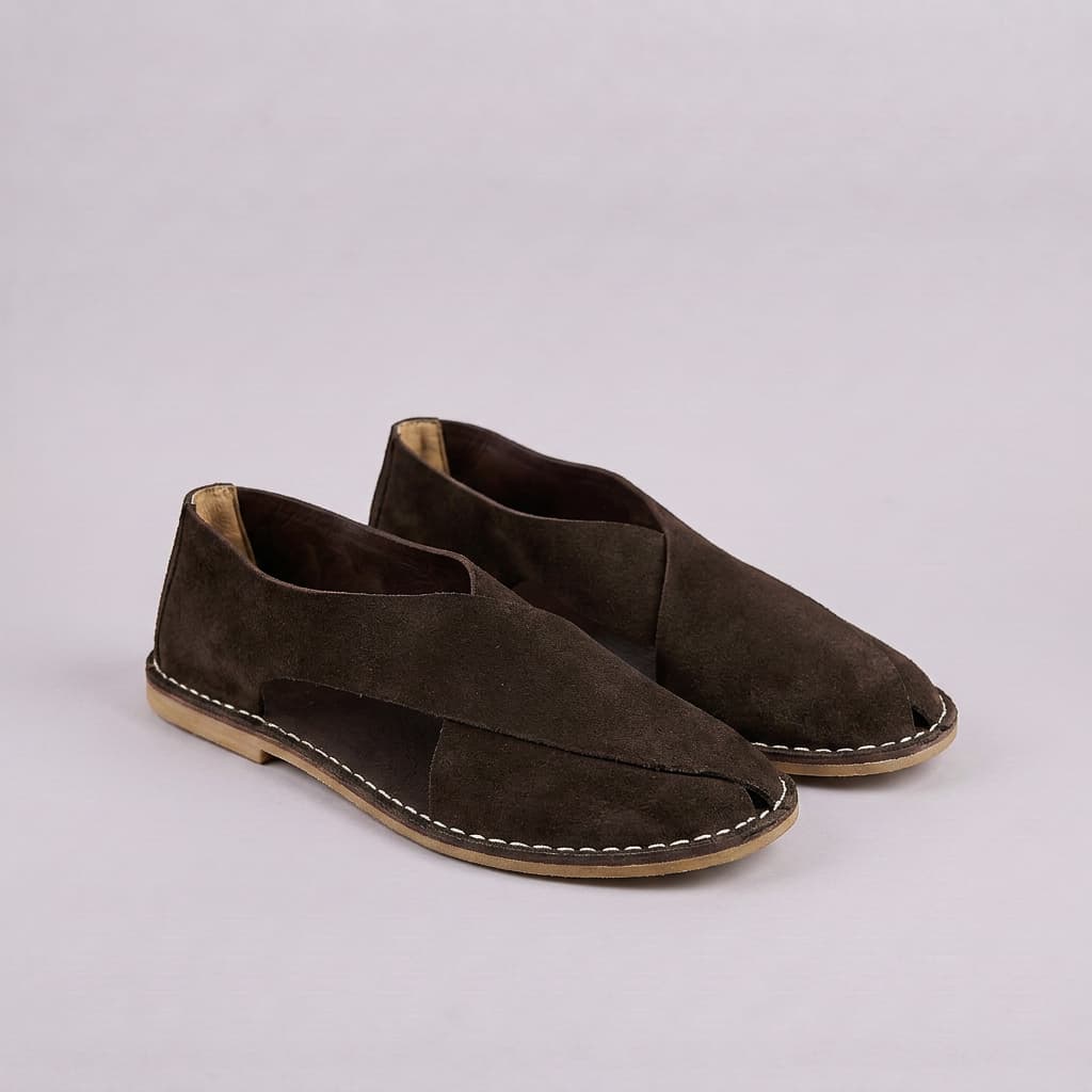 Pair of brown suede shoes on a light gray background