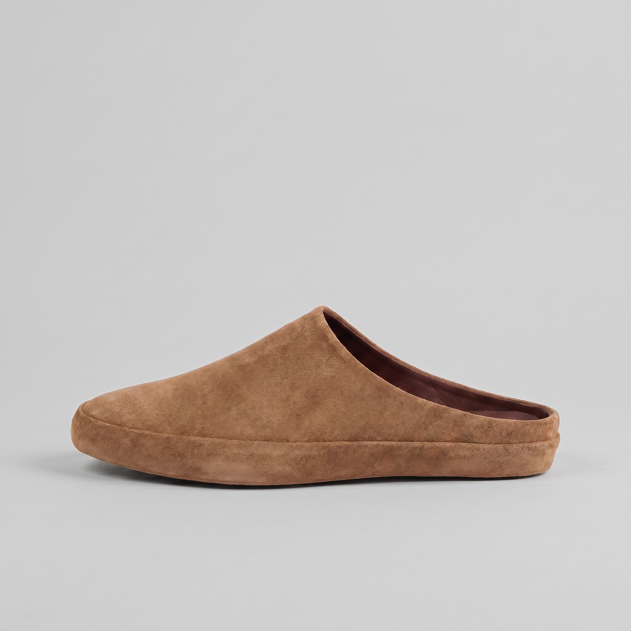 Brown slip-on shoe on a gray background